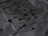 Close-up of a black motorcycle cover, featuring water droplets that highlight its durable, waterproof surface.